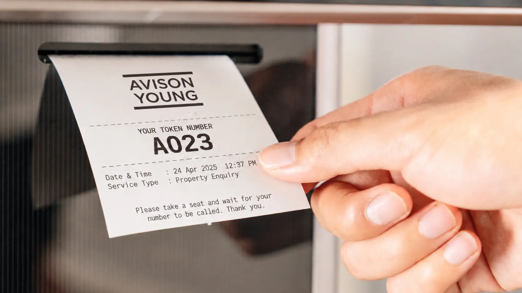 Printed queue token from the SUNMI FLEX 3 kiosk at Avison Young